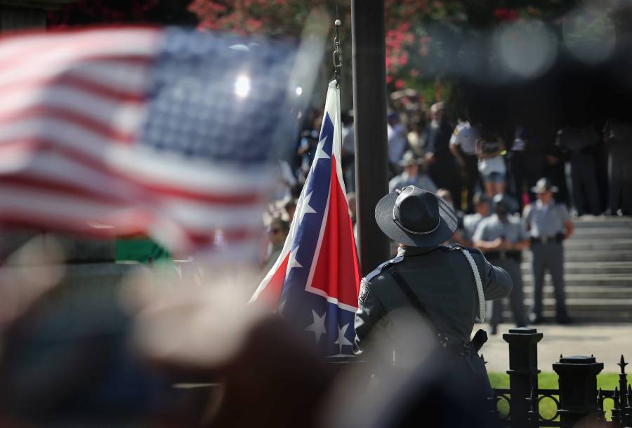 COLUMBIA, SC - JULY 10:  A South Carolina state police honor guard lowers the Confederate flag from the Statehouse grounds on July 10, 2015 in Columbia, South Carolina. Republican Governor Nikki Haley presided over the event after signing the historic legislation to remove the flag the day before.  (Photo by John Moore/Getty Images)