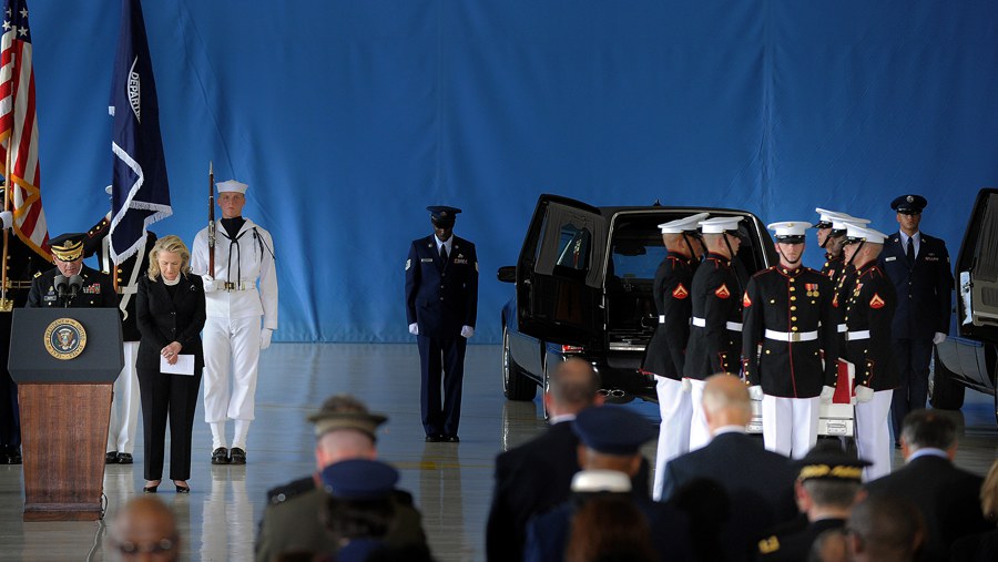 Secretary of State Hillary Clinton prays during the transfer of remains ceremony marking the return to the US of the remains of the four Americans killed in an attack in Benghazi, Libya, at the Andrews Air Force Base in Maryland on September 14, 2012. US Ambassador Christopher Stevens died on Tuesday along with three other Americans in the assault on the consular building in Benghazi, on the 11th anniversary of the September 11 attacks.