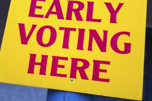Bright yellow "EARLY VOTING HERE" sign.